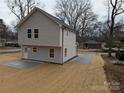 View of the backyard showing the rear facade, the lawn and a new concrete patio at 1302 Browdis Ave, Kannapolis, NC 28083