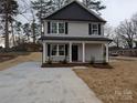 Charming two-story home featuring a fresh concrete driveway and newly seeded front yard at 1302 Browdis Ave, Kannapolis, NC 28083