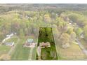An aerial view showcasing the property's spacious lot and its surrounding tree coverage at 1335 Blacksnake Rd, Stanley, NC 28164