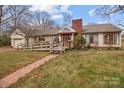 Charming single-story home with a brick chimney, accessible ramp, and welcoming front porch at 136 Coble Ave, Albemarle, NC 28001