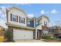 Charming two-story home boasts a stone facade, neutral siding, red shutters, and a spacious two-car garage at 15119 Oleander Dr, Charlotte, NC 28278