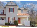 Inviting townhome with red accents, including shutters and a door, complemented by a well-maintained yard at 1751 Holliford Ct, Charlotte, NC 28215