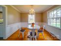 Bright dining room with stylish chandelier, round table, and ample natural light, ideal for Gathering meals and gatherings at 204 Julia Ave, Belmont, NC 28012