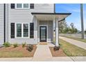 Charming front entryway with a black door, manicured landscaping, and sleek exterior design at 206 Freeland Ln, Charlotte, NC 28217