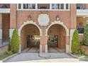 Arched garage entrance of a brick building, framed by manicured greenery at 2251 Selwyn Ave # 201, Charlotte, NC 28207