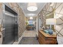 Stylish hallway with patterned wallpaper, modern lighting, and an elevator at 2251 Selwyn Ave # 201, Charlotte, NC 28207