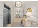 Elegant hallway features patterned wallpaper, modern lighting, and elevator access at 2251 Selwyn Ave # 201, Charlotte, NC 28207