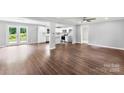 Bright, open-concept living room with hardwood floors, a ceiling fan, and French doors leading to the outdoors at 228 Tot Dellinger Rd, Cherryville, NC 28021
