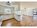 Bright kitchen featuring white cabinetry, stainless steel appliances, backsplash, and hardwood floors at 2604 Oxford Cir, Lancaster, SC 29720