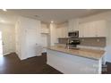 Modern kitchen featuring white cabinets, stainless steel appliances, and a center island at 3511 Nimbell Rd, Monroe, NC 28110