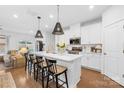 Bright, updated kitchen with island, modern appliances, white cabinets, and hardwood floors at 3512 Auburn Curb Rd, Charlotte, NC 28217