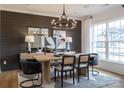Stylish dining room with a modern chandelier, wood table, and striking black accent wall at 3523 Rapport Ct # 026, Lancaster, SC 29720