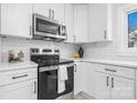Modern kitchen featuring stainless steel appliances, subway tile and white cabinetry at 3606 Buffalo Shoals Rd, Newton, NC 28658