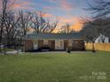Expansive backyard with a lush green lawn and a brick patio, ideal for outdoor entertaining and relaxation at 4201 Winedale Ln, Charlotte, NC 28205