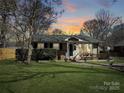 Charming single-story home with a well-manicured front lawn and a welcoming porch, perfect for enjoying peaceful evenings at 4201 Winedale Ln, Charlotte, NC 28205