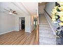 Spacious living area with wood floors, a ceiling fan and a staircase at 530 Pate Dr, Fort Mill, SC 29715