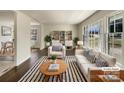 Bright living room with hardwood floors, large windows and stylish furniture at 5901 Craftsbury Dr, Charlotte, NC 28215