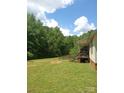 View of the home's backyard with a cozy porch and surrounding greenery at 607 Anthony Grove Rd, Crouse, NC 28033