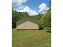 Side view of the house displaying the home's siding and well maintained lawn at 607 Anthony Grove Rd, Crouse, NC 28033
