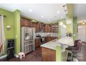 Open concept kitchen with stainless steel appliances, granite countertops, and breakfast bar at 6211 Canyon Trl, Denver, NC 28037