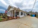 Inviting home exterior with a covered porch and spacious driveway, set in a tranquil neighborhood at 719 Washington St, Cramerton, NC 28032