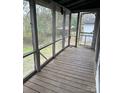 Spacious porch with wood floors and screen panels, offering a view of the surrounding yard at 1010 13Th St # 11, Lancaster, SC 29720