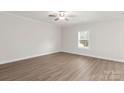 Neutral bedroom with wood-look flooring and a window at 107 Adams Tree Way, Troutman, NC 28166