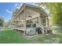 Charming exterior view with covered porch and deck, enhancing the home's appeal for outdoor enjoyment and relaxation at 109 Pembrooke Trl # F171, Mount Gilead, NC 27306