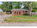 Quaint red brick home with a well-manicured lawn and a convenient carport at 1125 Mcdow Dr, Rock Hill, SC 29732