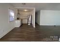 Open living space with modern floors, leading to the kitchen and dining area at 1125 Mcdow Dr, Rock Hill, SC 29732