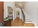 A grand foyer features hardwood floors, arched doorways, and a staircase with iron railings at 11311 Mcclure Manor Dr, Charlotte, NC 28277