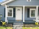 Inviting front porch with white columns and black shutters create a classic curb appeal at 125 Ashe St, Gastonia, NC 28056