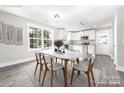 Open concept dining area with a modern table, chairs, and a view to the kitchen at 1308 Jay Ave, Gastonia, NC 28052