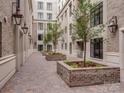 Charming courtyard with brick planters and classic lantern lighting at 1333 Queens Rd # B1, Charlotte, NC 28207