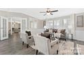 Inviting living room with modern decor, hardwood flooring, and plenty of natural light, perfect for relaxation at 140 Sanford Ln, New London, NC 28127