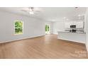 Spacious living room with light wood floors, big windows, and modern ceiling fan at 1534 Doran Ter, Richburg, SC 29729