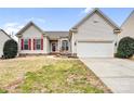 Charming home with a well-manicured lawn, red shutters, and a two-car garage at 162 Pecan Hills Dr, Mooresville, NC 28115