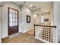 Elegant foyer with hardwood floors, staircase, and decorative lighting, creating a welcoming entrance to the home at 17927 Culross Ln, Charlotte, NC 28278