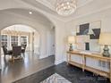 Spacious foyer with decorative lighting, black floors, console table and view into adjacent rooms at 2004 Lombardy Cir, Charlotte, NC 28203