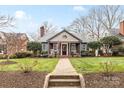 Beautiful front yard with a manicured lawn leading to the charming home and front porch at 2009 Charlotte Dr, Charlotte, NC 28203