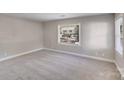Carpeted bedroom with neutral walls and natural light from two windows at 2328 Edison St, Charlotte, NC 28206