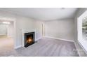 Bright living room with a cozy fireplace, neutral paint, plush carpet, and ample natural light at 2328 Edison St, Charlotte, NC 28206