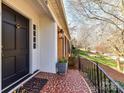 Close-up of a charming front porch with mosaic tile and a black front door at 2710 Goneaway Rd, Charlotte, NC 28210