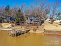 Waterfront home with a private dock and sandy beach access creating a peaceful and serene living environment at 3030 Point Clear Dr, Tega Cay, SC 29708