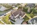 Beautiful aerial view of a home with a long driveway and lush landscaping in a quiet neighborhood at 401 Pecan Ridge Ct, Weddington, NC 28104