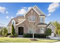 Beautiful home featuring a combination of stone and siding, complemented by manicured landscaping at 401 Pecan Ridge Ct, Weddington, NC 28104