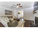 Inviting living room featuring dark floors, a gray couch, and white paint at 4224 Park South Station Blvd, Charlotte, NC 28210