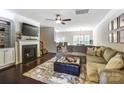 Cozy living room boasts a fireplace, dark floors, neutral paint, and lots of natural light at 4224 Park South Station Blvd, Charlotte, NC 28210