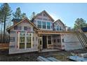 Under construction exterior showcasing the home's framing and window placement on a sunny day at 44389 Us 52 N Hwy, Richfield, NC 28137