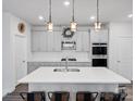 Spacious kitchen with gray cabinetry, quartz countertops, and stainless steel appliances at 518 Palmarosa St, Fort Mill, SC 29715